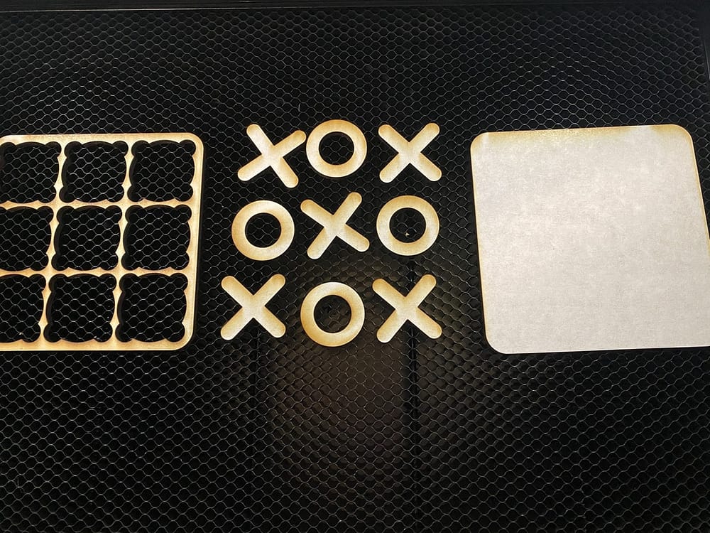 tic-tac-toe board pieces cut out using the laser