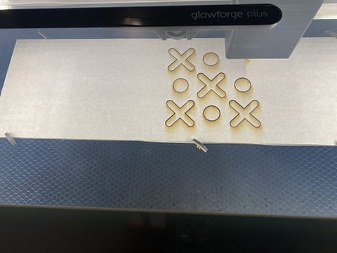 Laser cutting, the "X" 's and the inner circle in the "O" 's first.