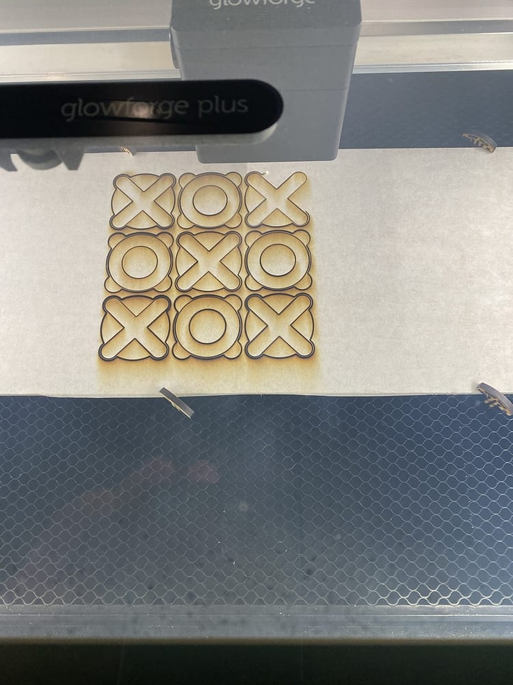 The laser cut the shapes containing both the "X" and "O" characters